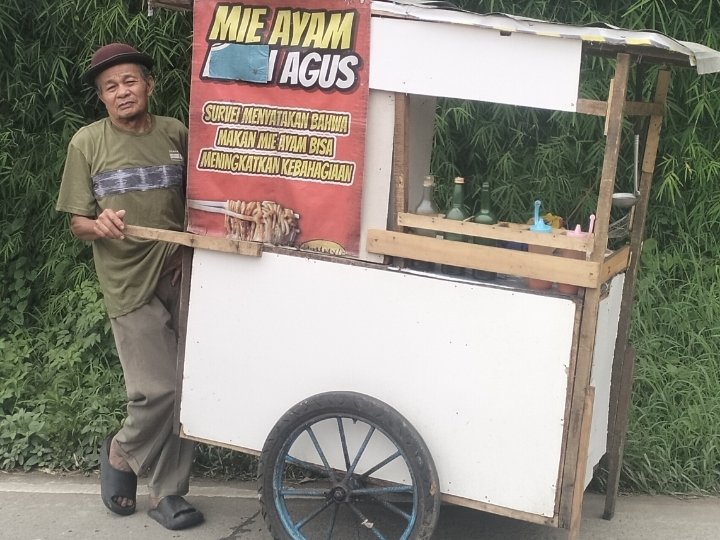 Agus Pedagang Mie Ayam Keliling saat berjualan dengan gerobaknya yang sempat tertabrak motor beberapa waktu lalu