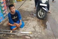 Kefin (23 tahun) Tuna Grahita yang menderita cacat kakinya yang viral sering mangkal ditengah jalan Tapos Tigaraksa (sumber foto ; warga yang peduli dan memindahkan Kefin ke pinggir jalan)